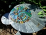 Garden furniture set, table and two stools: Ammonite design