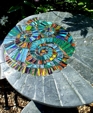 Garden furniture set, table and two stools: Ammonite design